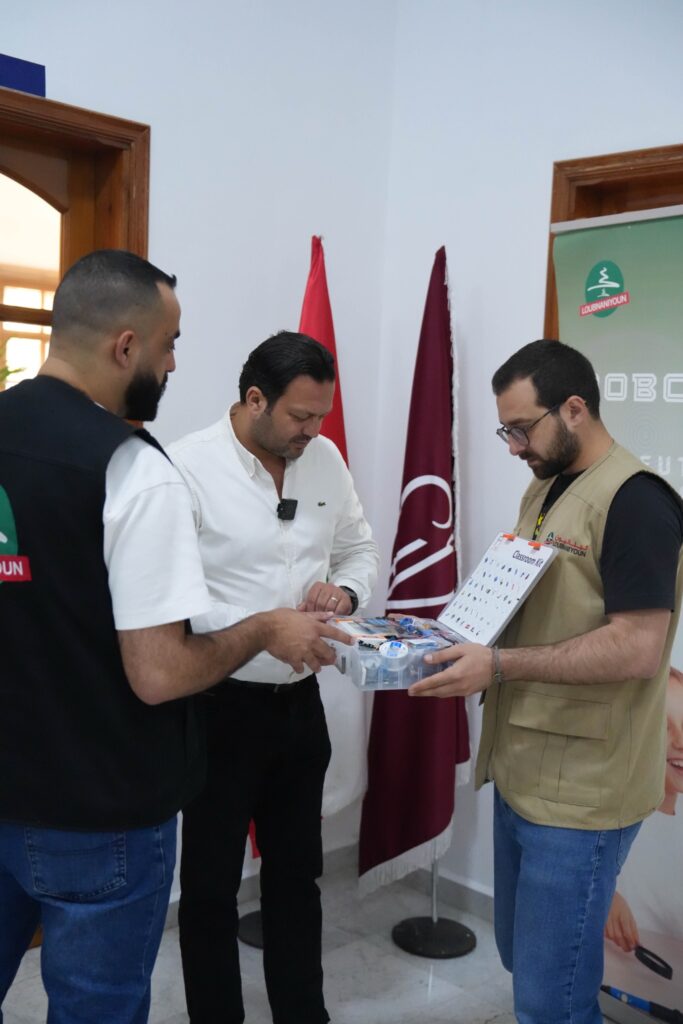 Loubnaniyoun staff presenting a classroom robotics kit