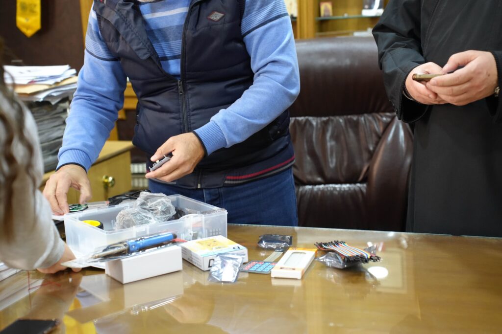 Close-up of a Loubnaniyoun robotics classroom kit with breadboard and components