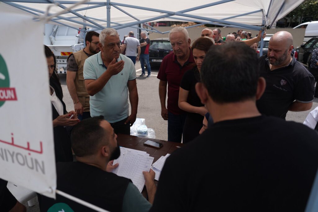Loubnaniyoun staff keeping signed beneficiary records at a distribution point