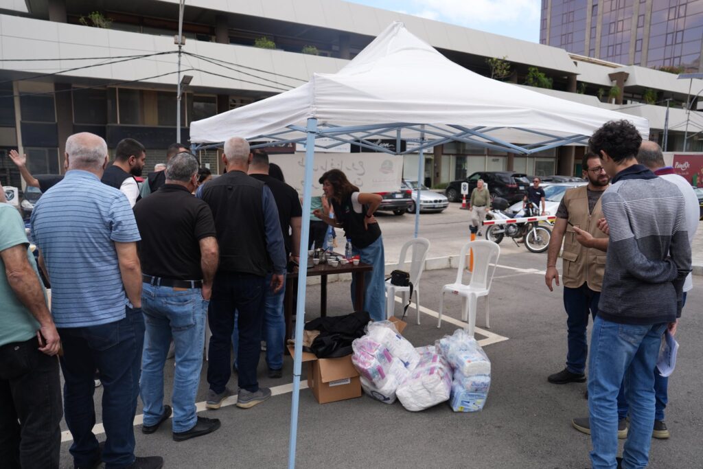 Displaced families at a Loubnaniyoun distribution tent in Beirut