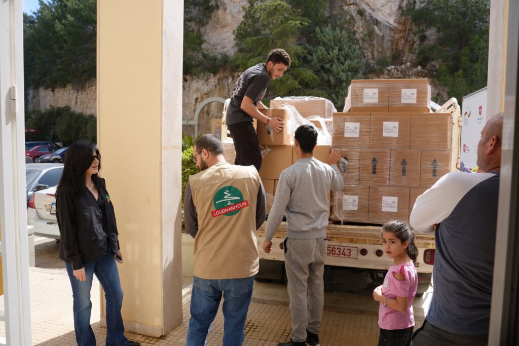 Loubnaniyoun and Stirling Foundation aid boxes being unloaded from a truck at a shelter