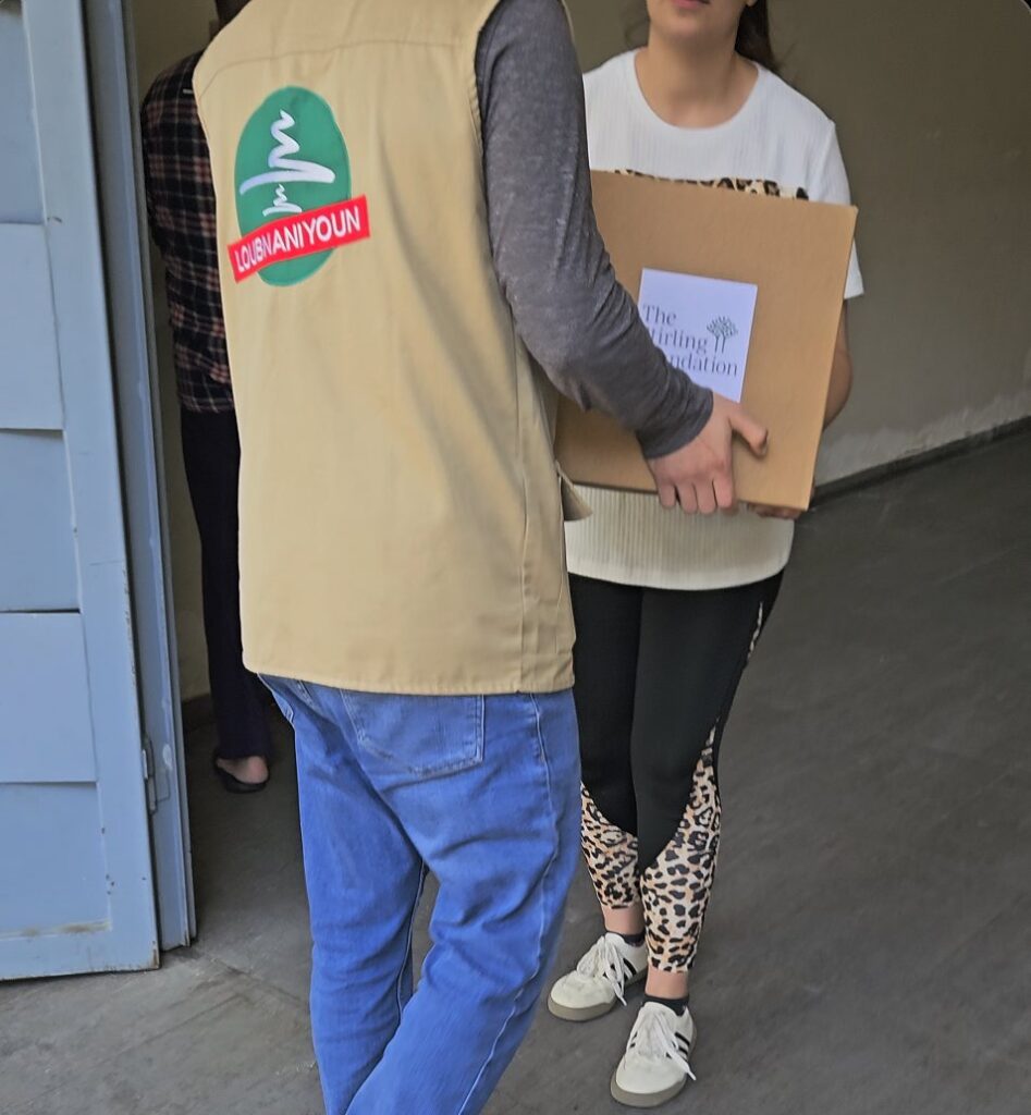 Volunteers carrying Loubnaniyoun aid boxes