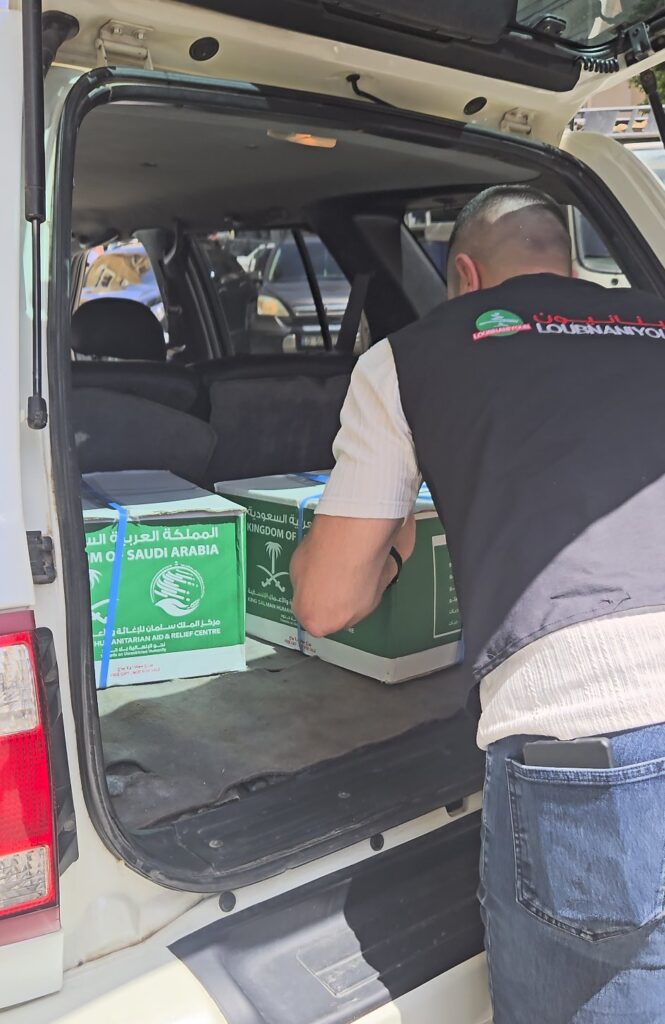 Volunteers loading food boxes for delivery to families