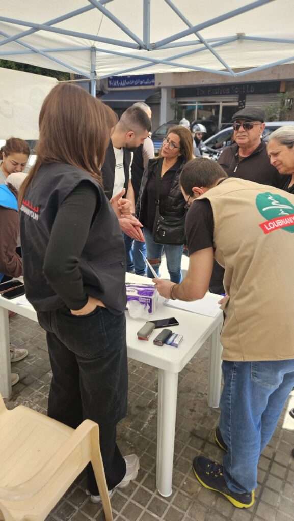 Volunteers registering beneficiaries at the food box distribution