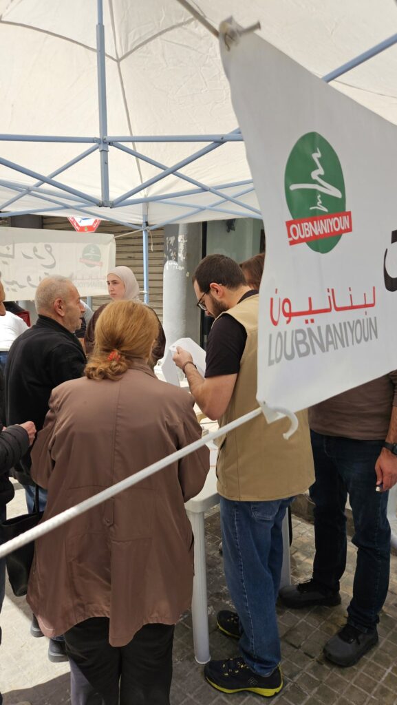 Displaced families registering at the Loubnaniyoun food distribution tent