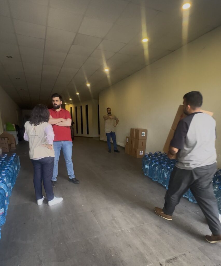 Boxes and drinking water staged inside a shelter for displaced families