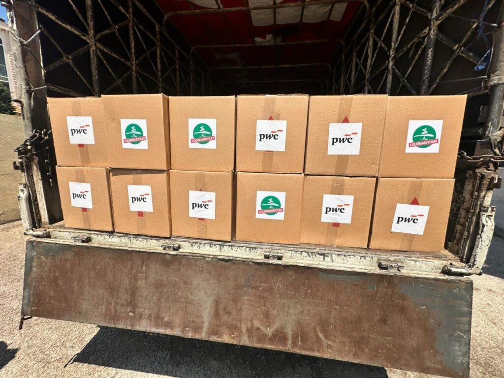 A truck loaded with PwC and Loubnaniyoun hygiene-kit boxes for distribution