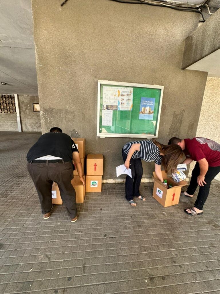 Team checking hygiene-kit contents at a shelter