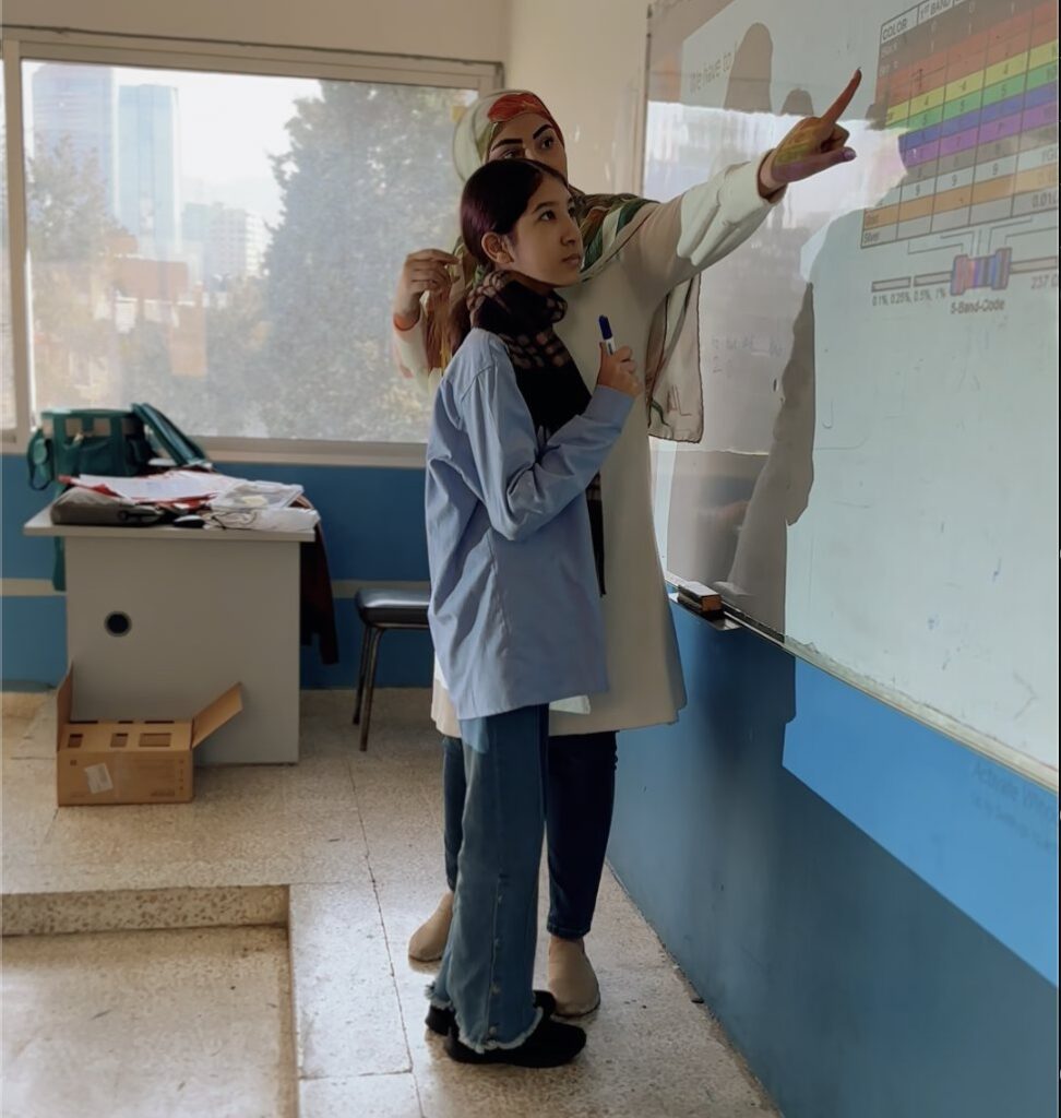 Instructor explaining a concept at the whiteboard