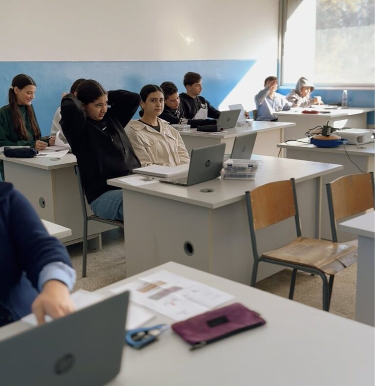 Students following a robotics workshop on their laptops